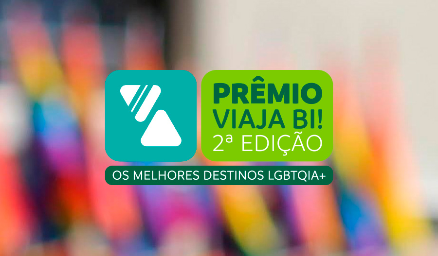 Logotipo do Prêmio Viaja Bi! 2ª Edição - Os melhores destinos LGBTQIA+, sobre um fundo colorido e desfocado.